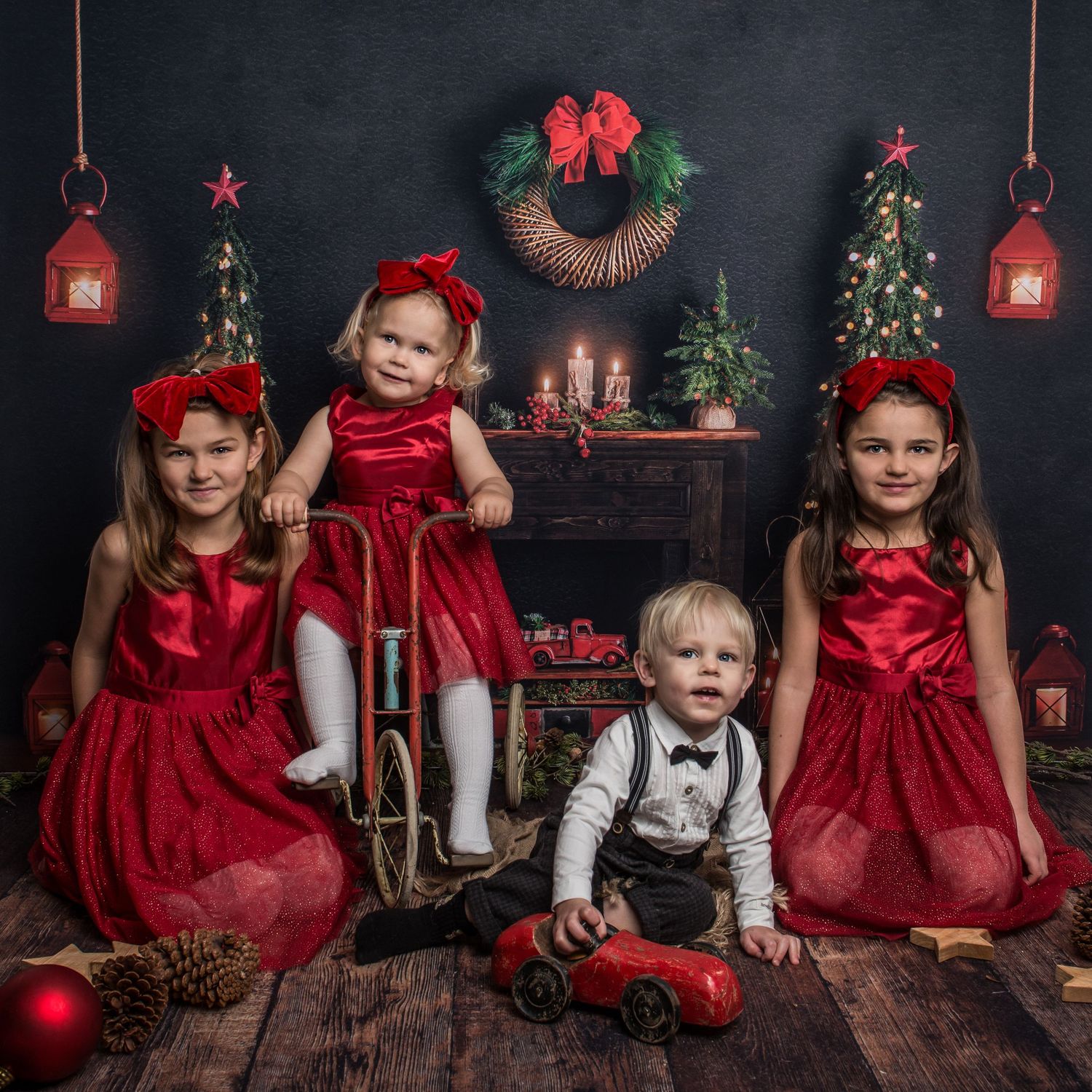 Holiday portrait setting with red and white color scheme, decorated Christmas trees and lanterns.
