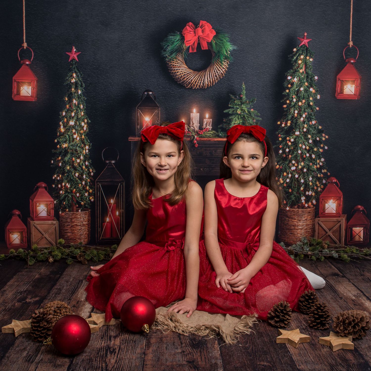 Christmas photography backdrop featuring decorated trees, red lanterns and rustic wood flooring.