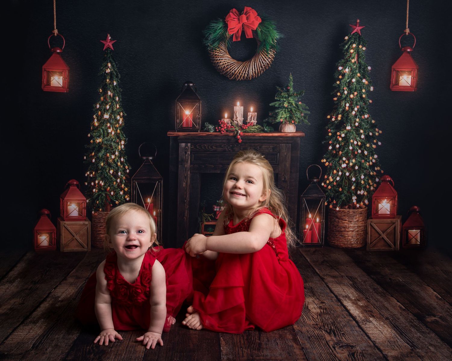 Festive Christmas photography setup with decorated trees and red holiday accents.