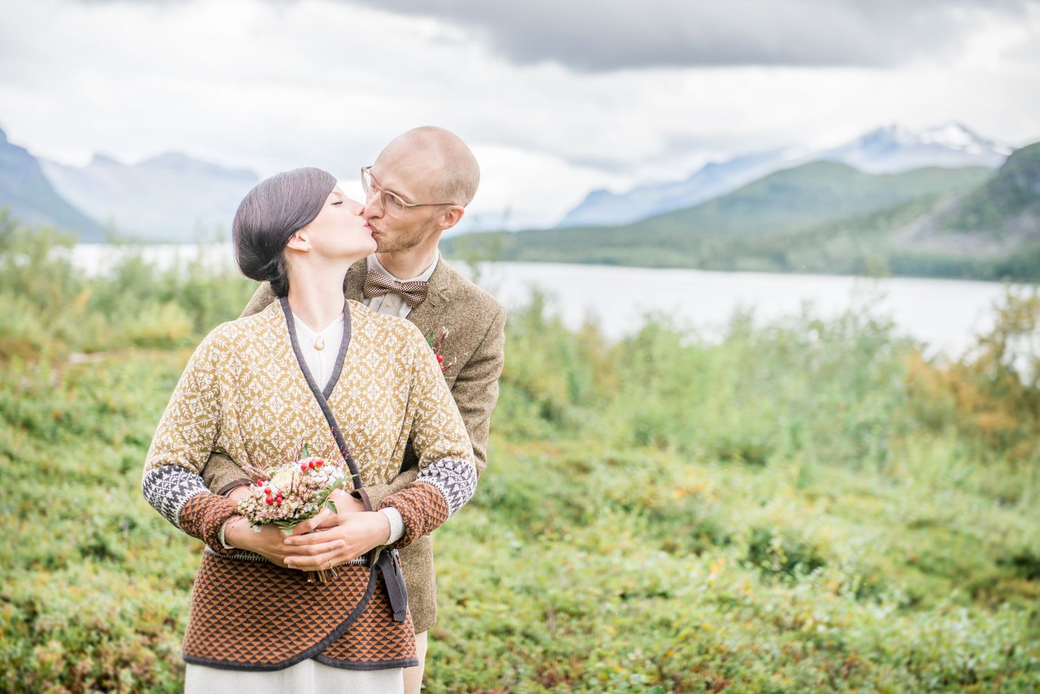 Intimate outdoor portrait session with mountain peaks in the background.