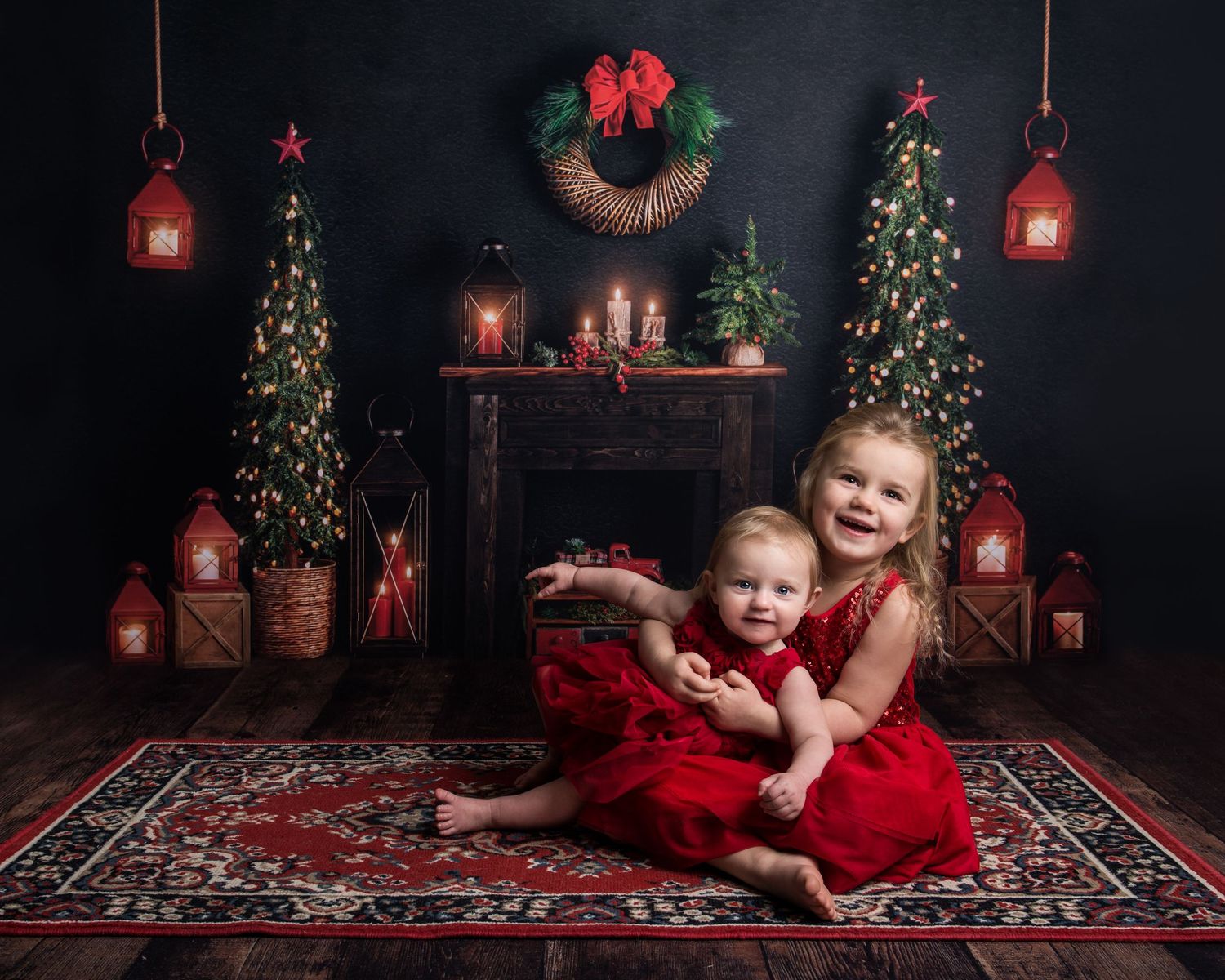 Christmas photo backdrop with red carpet, decorated trees and rustic wooden floor.