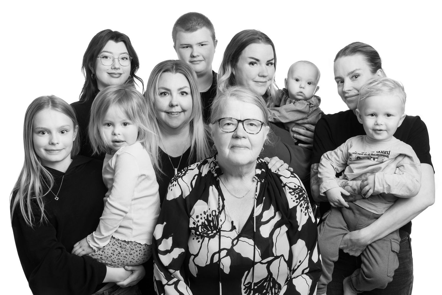 Black and white family portrait collage showing multiple generations in casual poses.