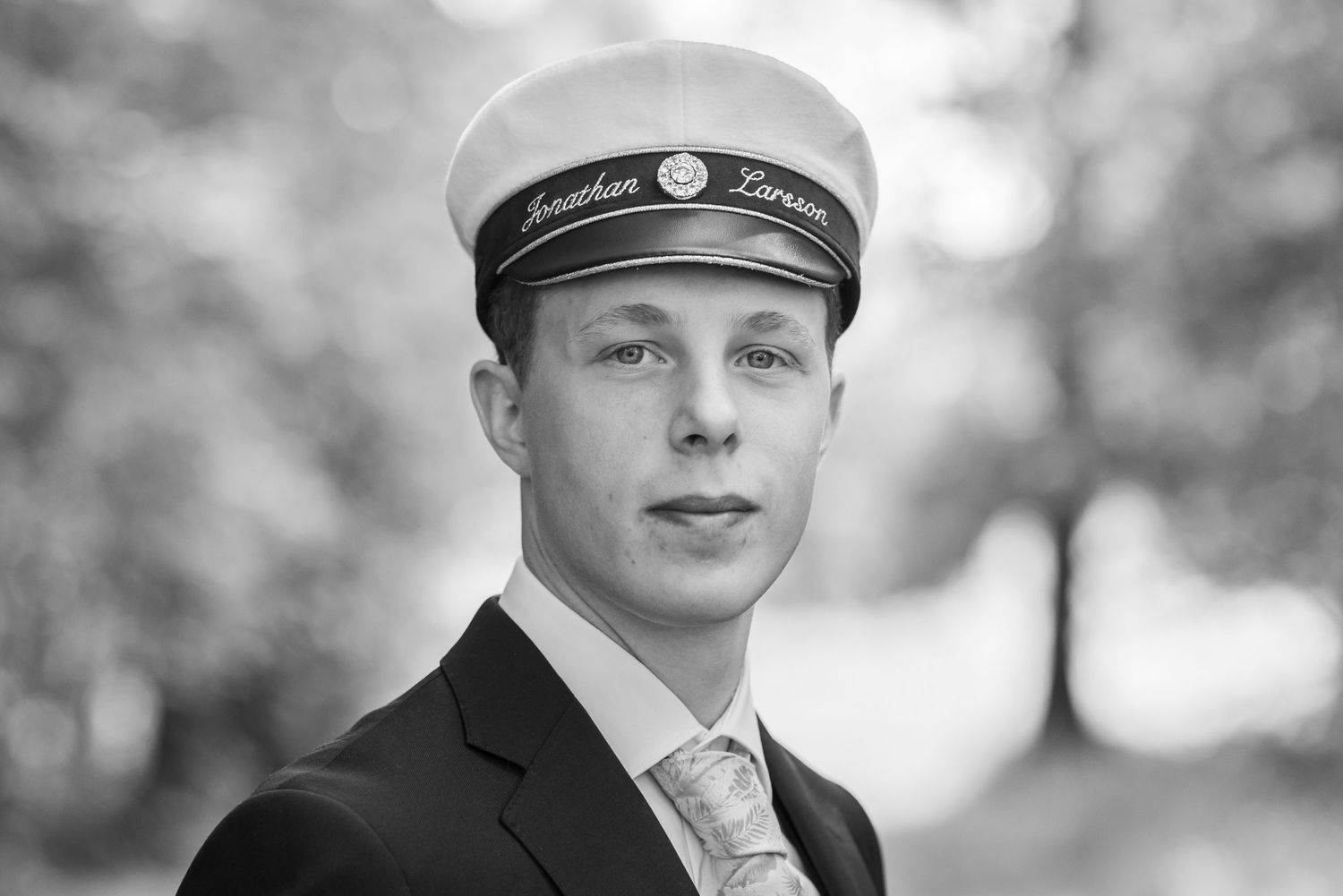 Black and white portrait series showing different angles in formal attire.