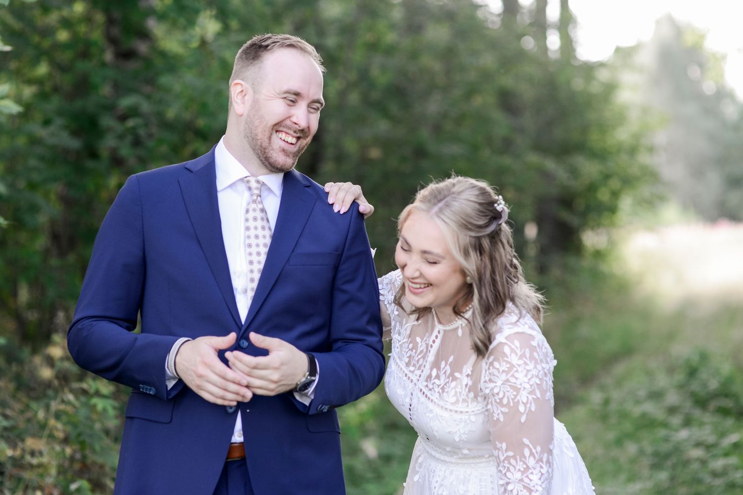 Natural light engagement photos showing playful interactions in a wooded setting.