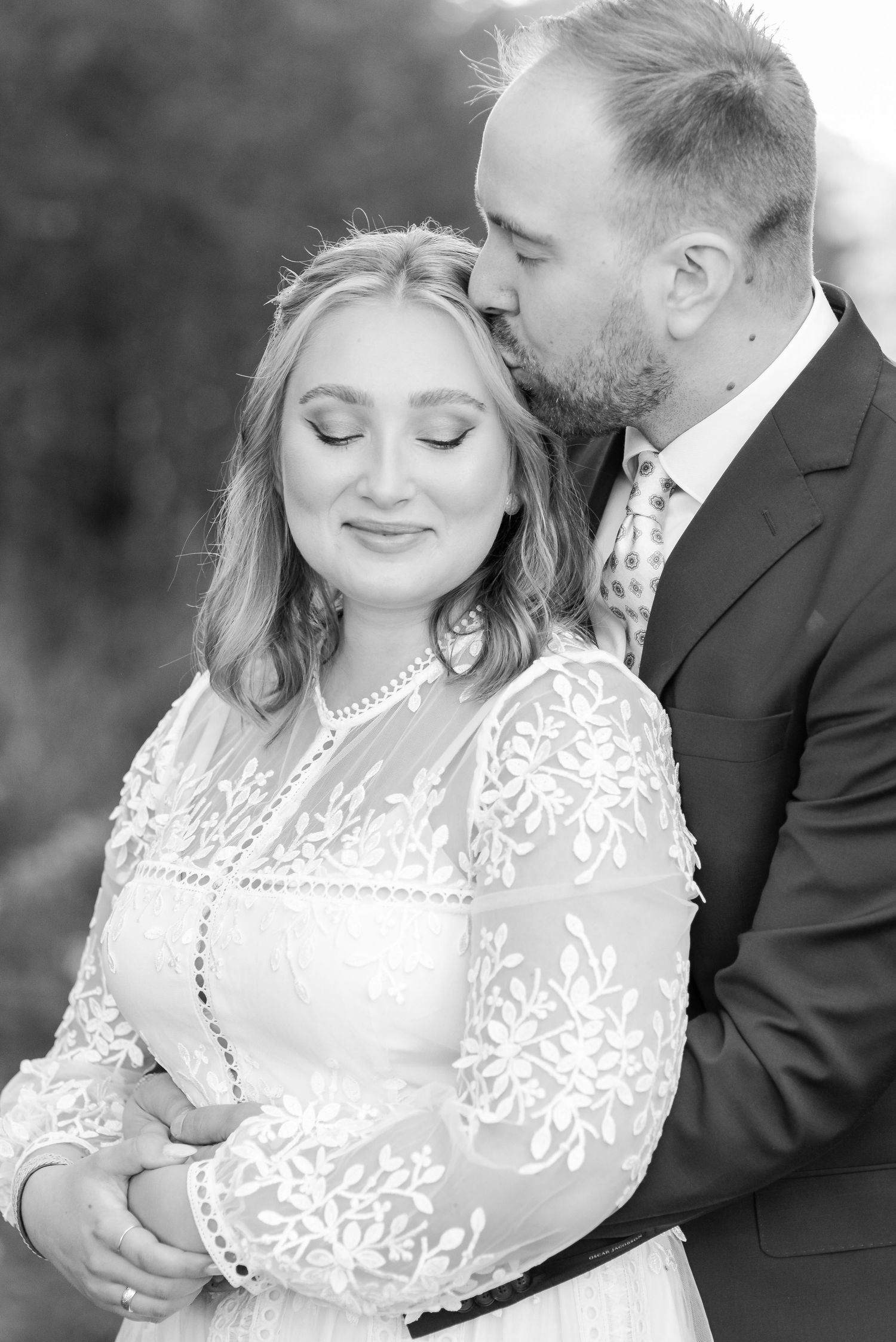 Black and white romantic portraits showing tender moments between a couple in formal wear.