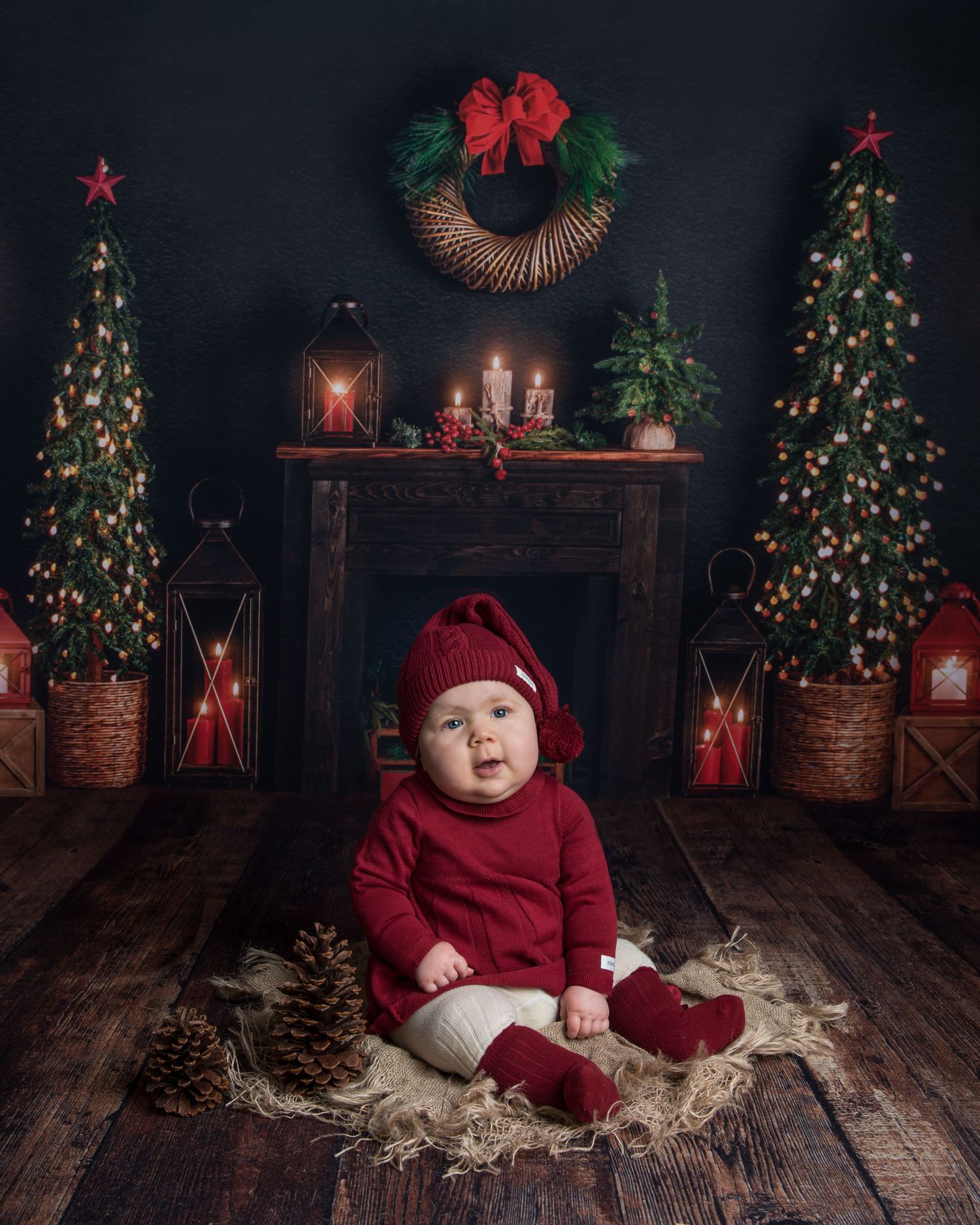 Cozy Christmas setup with decorated trees, red lanterns and rustic wood floor.