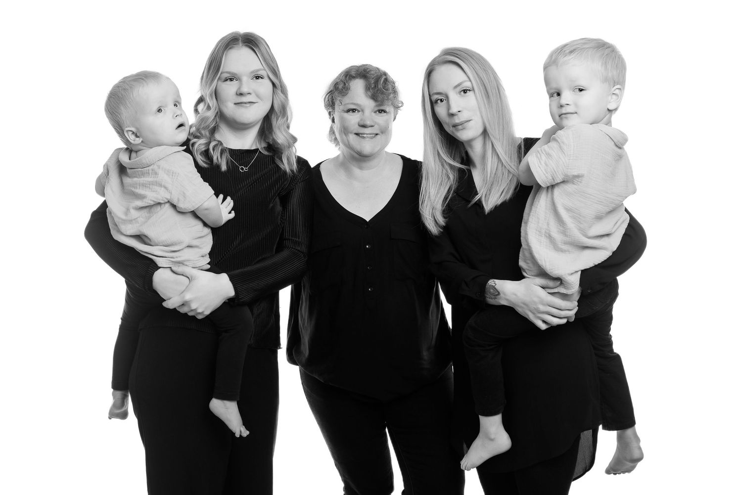Family group portrait with everyone wearing matching black outfits.