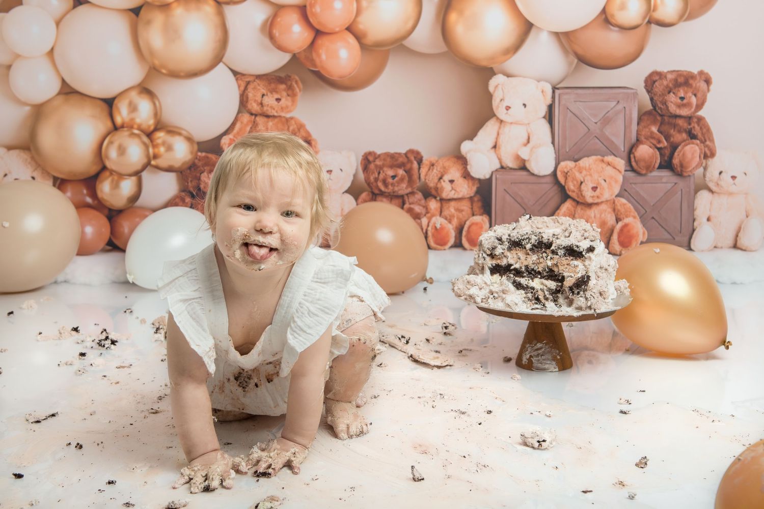 A cake smash photo session shows a happy baby enjoying their birthday dessert.