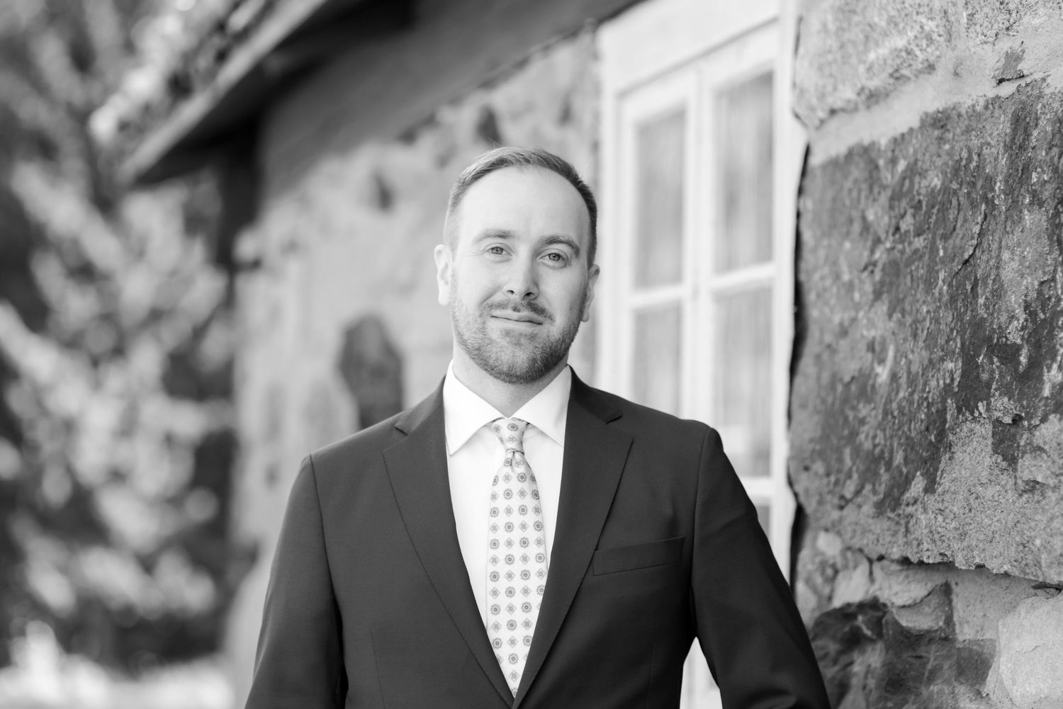 Series of black and white portraits showing different angles against stone architecture.