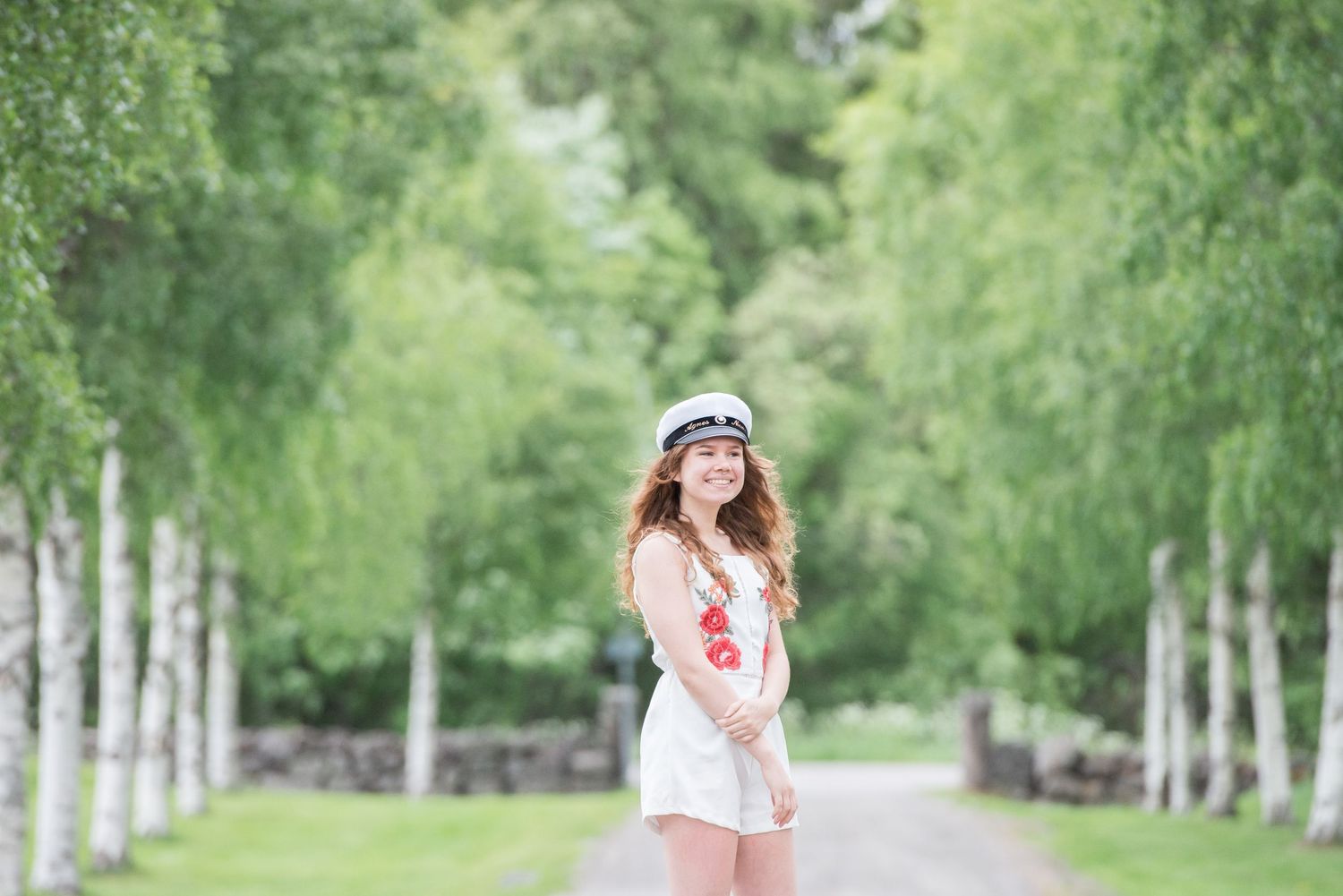 Romantic portraits along a birch tree-lined path in summer.