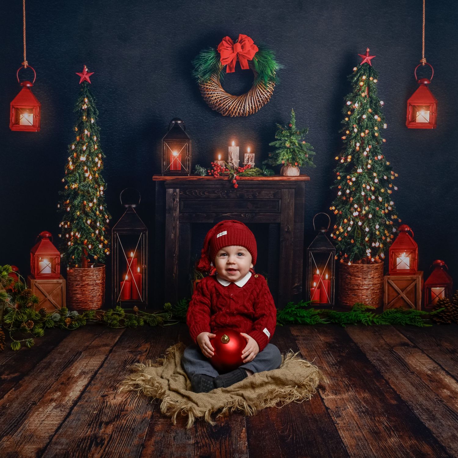 Dark moody Christmas scene with decorated trees, red ornaments and rustic wooden elements.