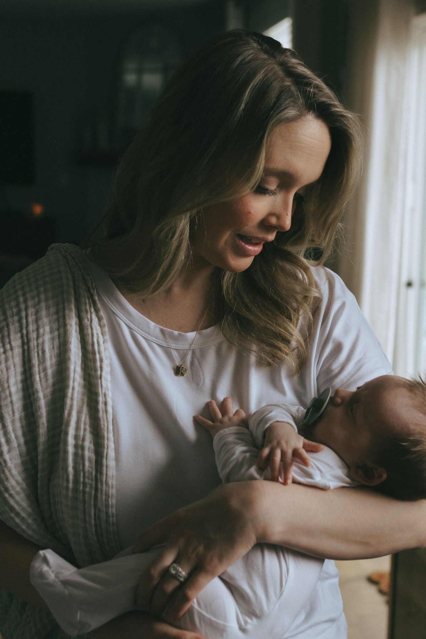 A mother holding her newborn baby boy.
