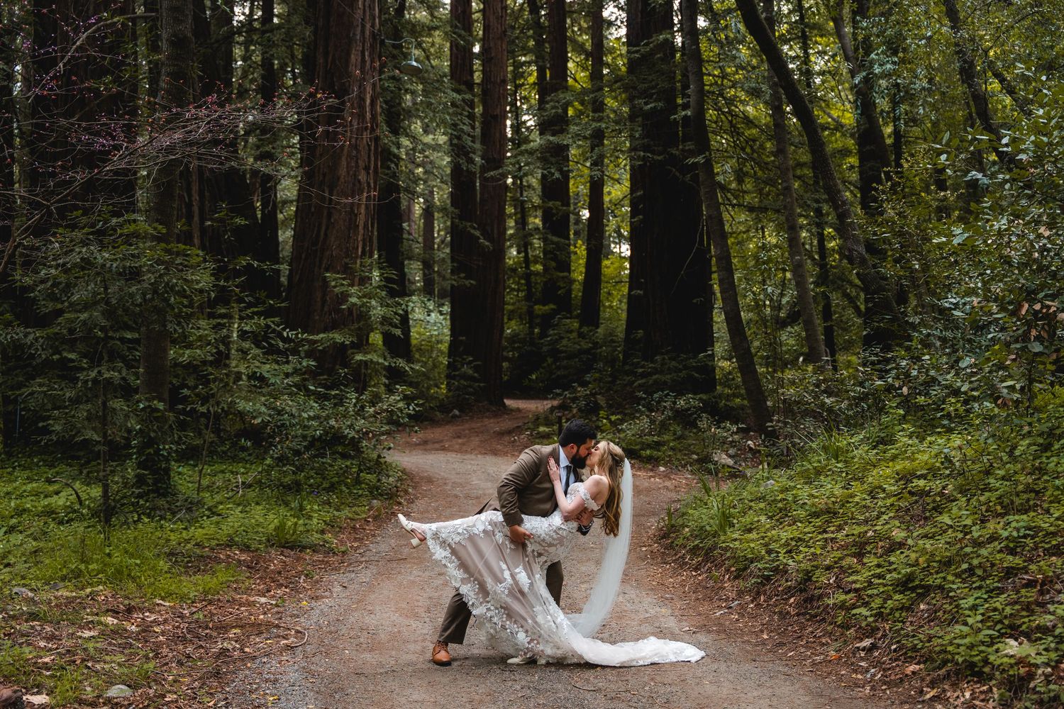 A dip kiss between bride and groom at a Big Sur Elopement