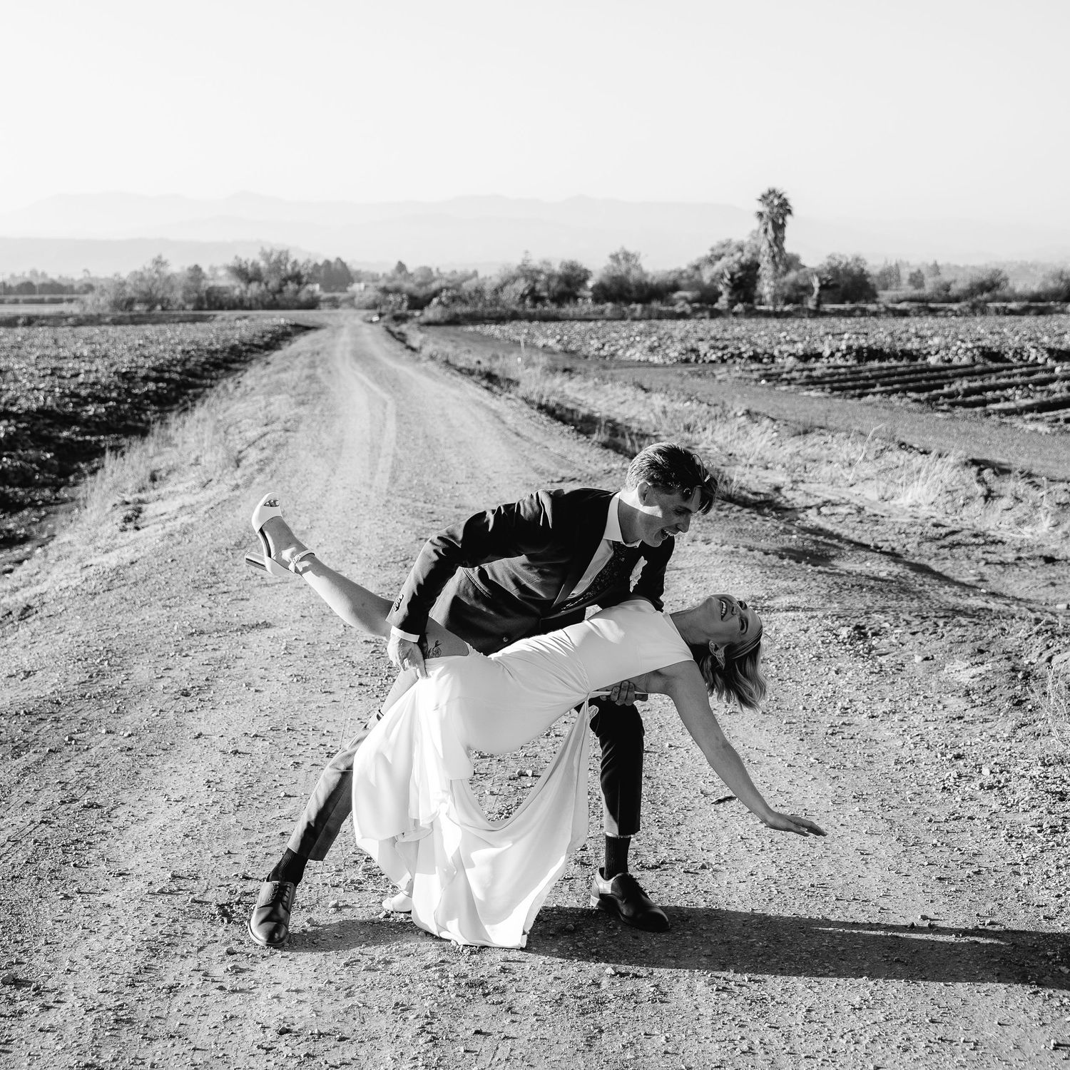 Black and white photo of a couple in wedding attire sharing a romantic dip pose at a Casi Cielo Wedding