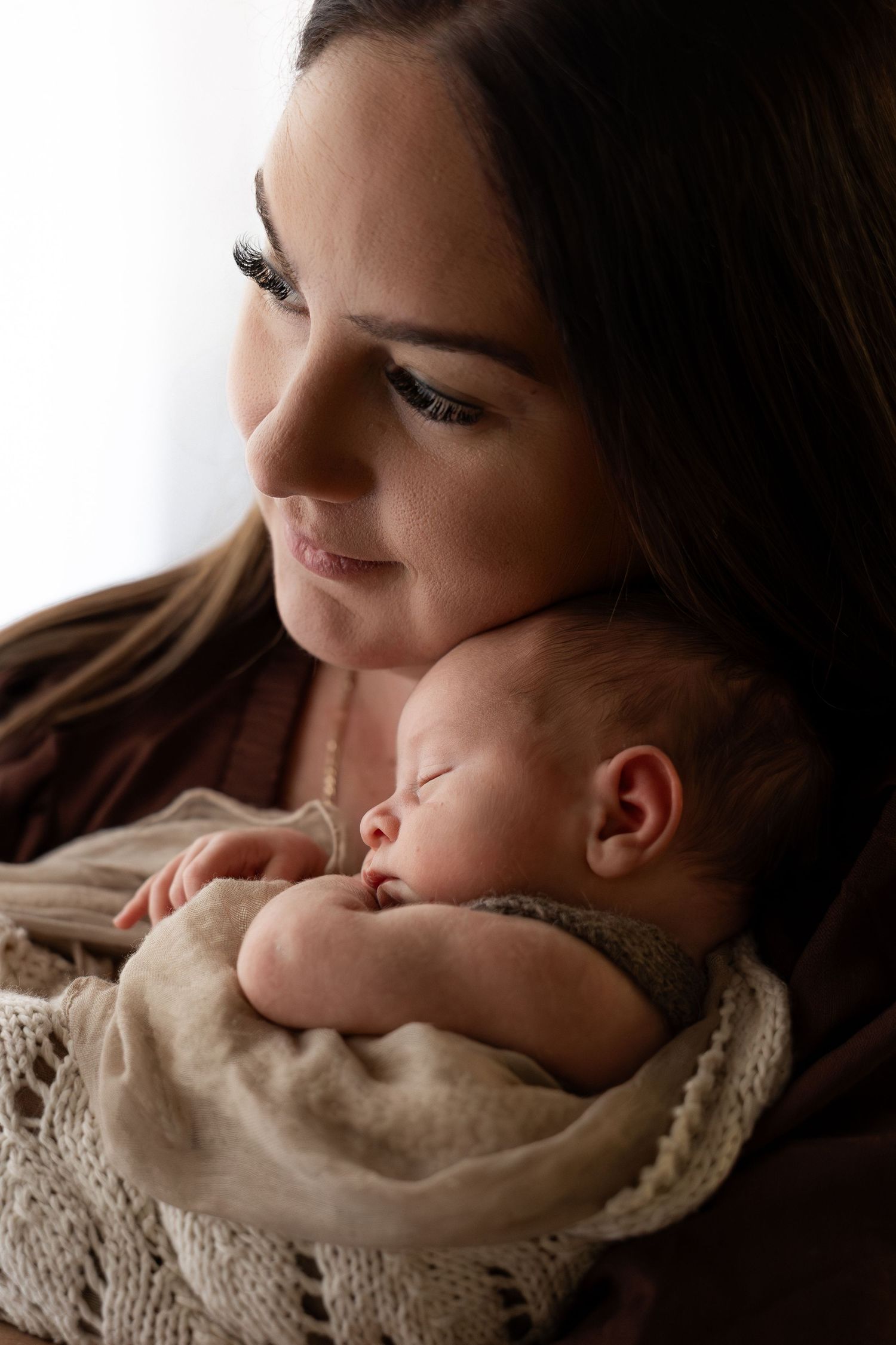 A close up intimate photo of the connection between a mother and her newborn baby