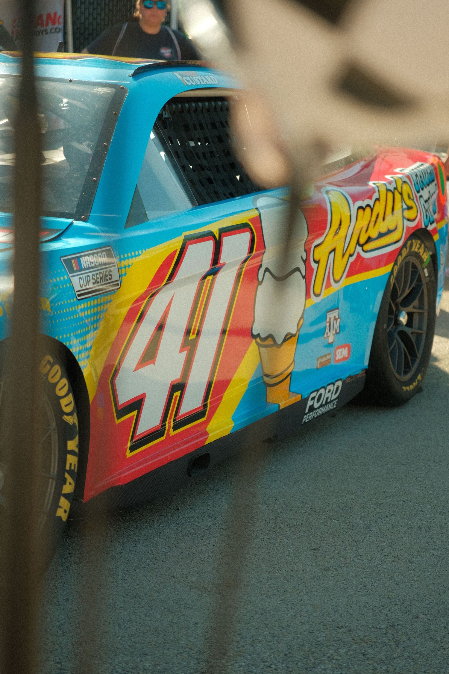 NASCAR race car number 41 with Andy's sponsorship in blue and red livery on Goodyear tires at a racing event.