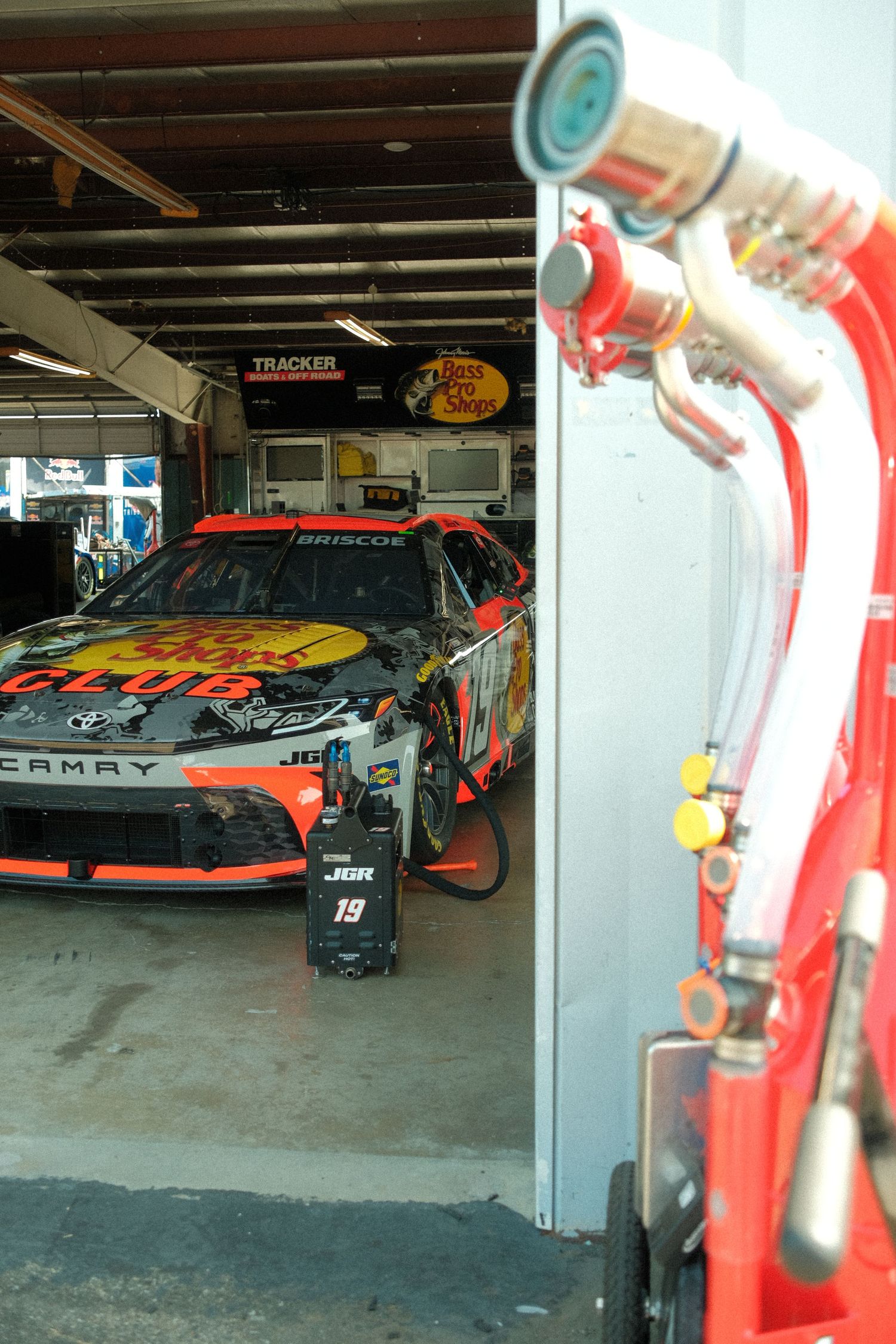 Bass Pro Shops number 19 Chase Briscoe Toyota Camry NASCAR Cup Series car parked inside the Tracker garage stall at Watkins Glen.