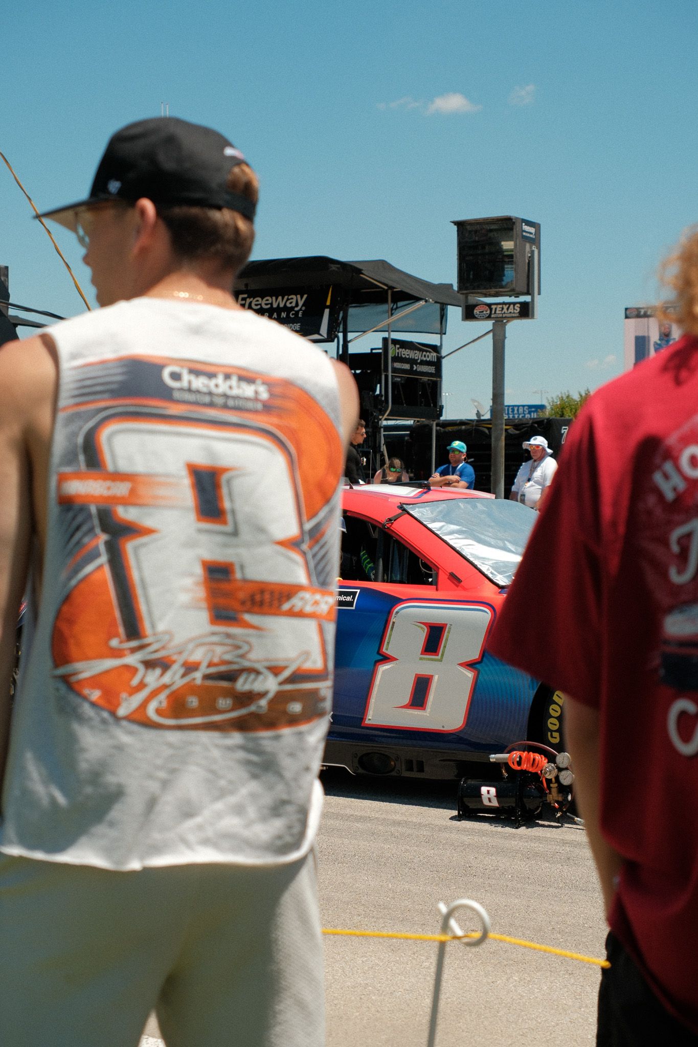 NASCAR fans view the number 8 Dale Earnhardt Jr. race car in the pit lane at Texas Motor Speedway.