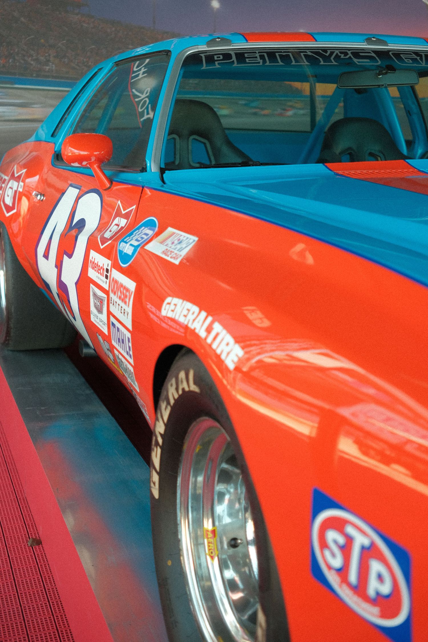 Richard Petty's iconic #43 red and blue STP NASCAR race car on display, featuring General Tire sponsorship decals.