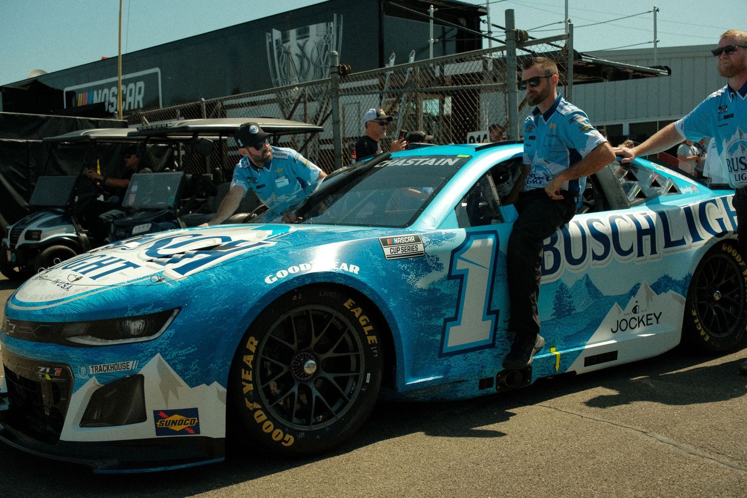 NASCAR Busch Light number 1 Ross Chastain Chevrolet Camaro ZL1 being pushed through the garage area by pit crew members at Watkins Glen.