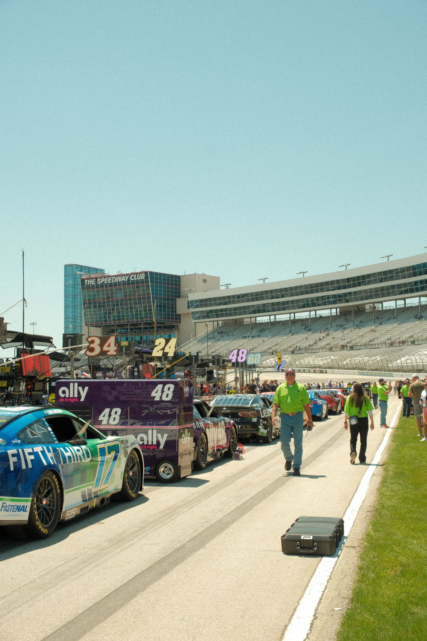 NASCAR cars including the 48 Ally and 17 Fifth Third lined up in pit road at Texas Motor Speedway.