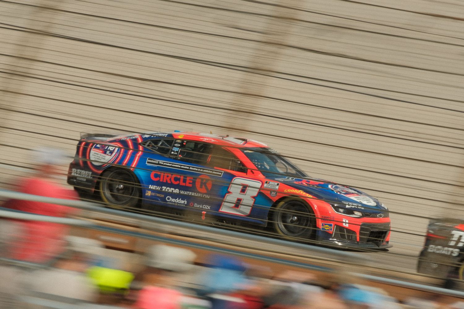 NASCAR Circle K No. 2 race car speeding on a banked track during a competitive race event.