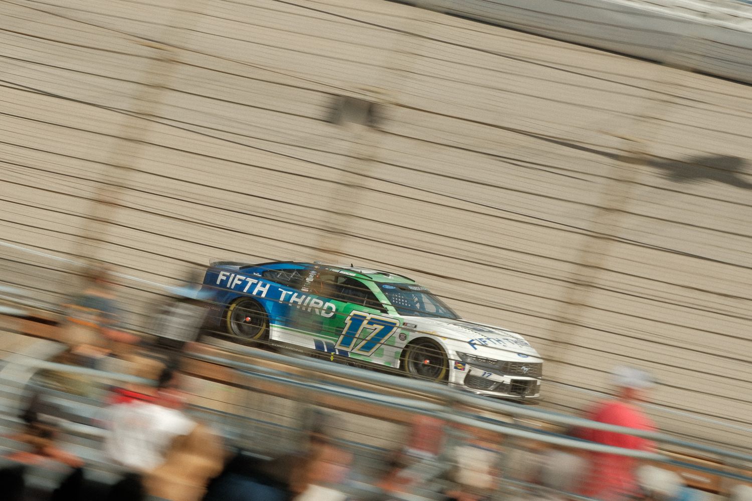 Fifth Third Bank NASCAR No. 17 race car speeds along banked track during race.