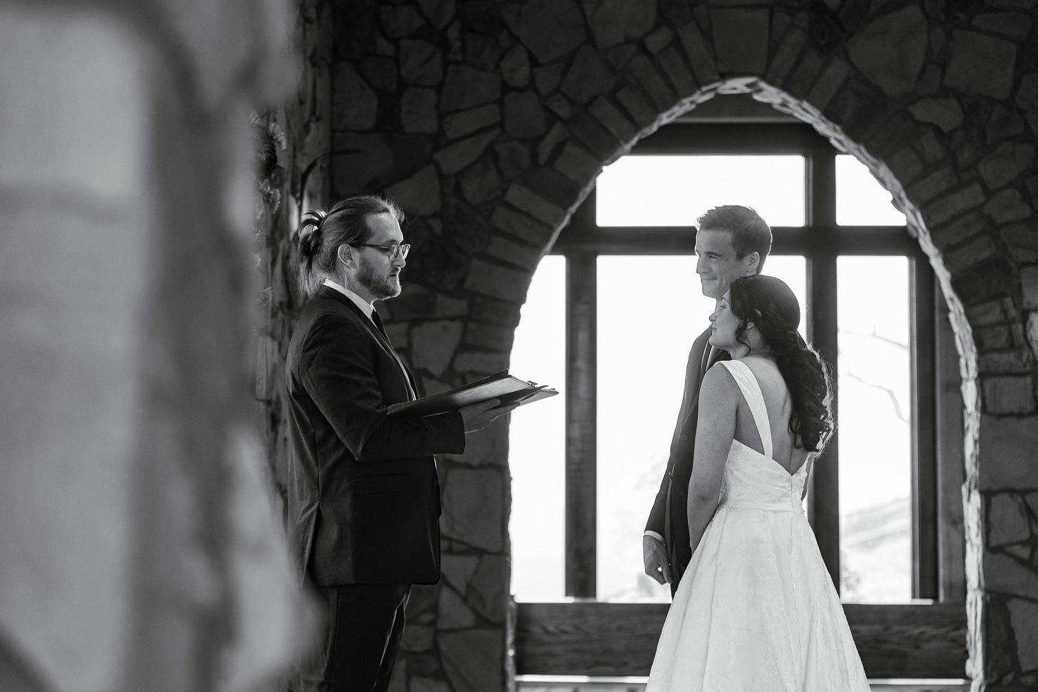 A black and white wedding photo collage showing intimate moments between the bride and groom in various romantic poses.