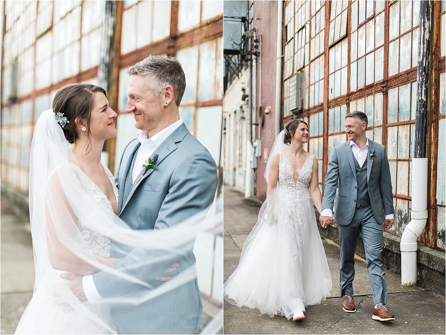 Wedding couple embraces and walks along industrial building exterior.