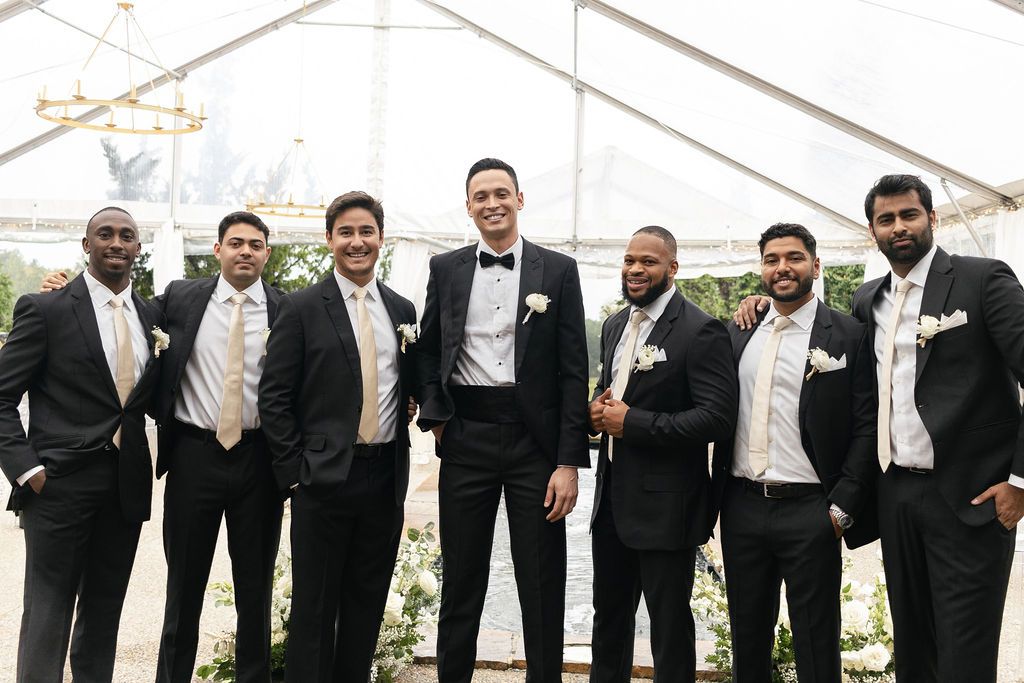 Groom and groomsmen under the clear tent at hotel domestique