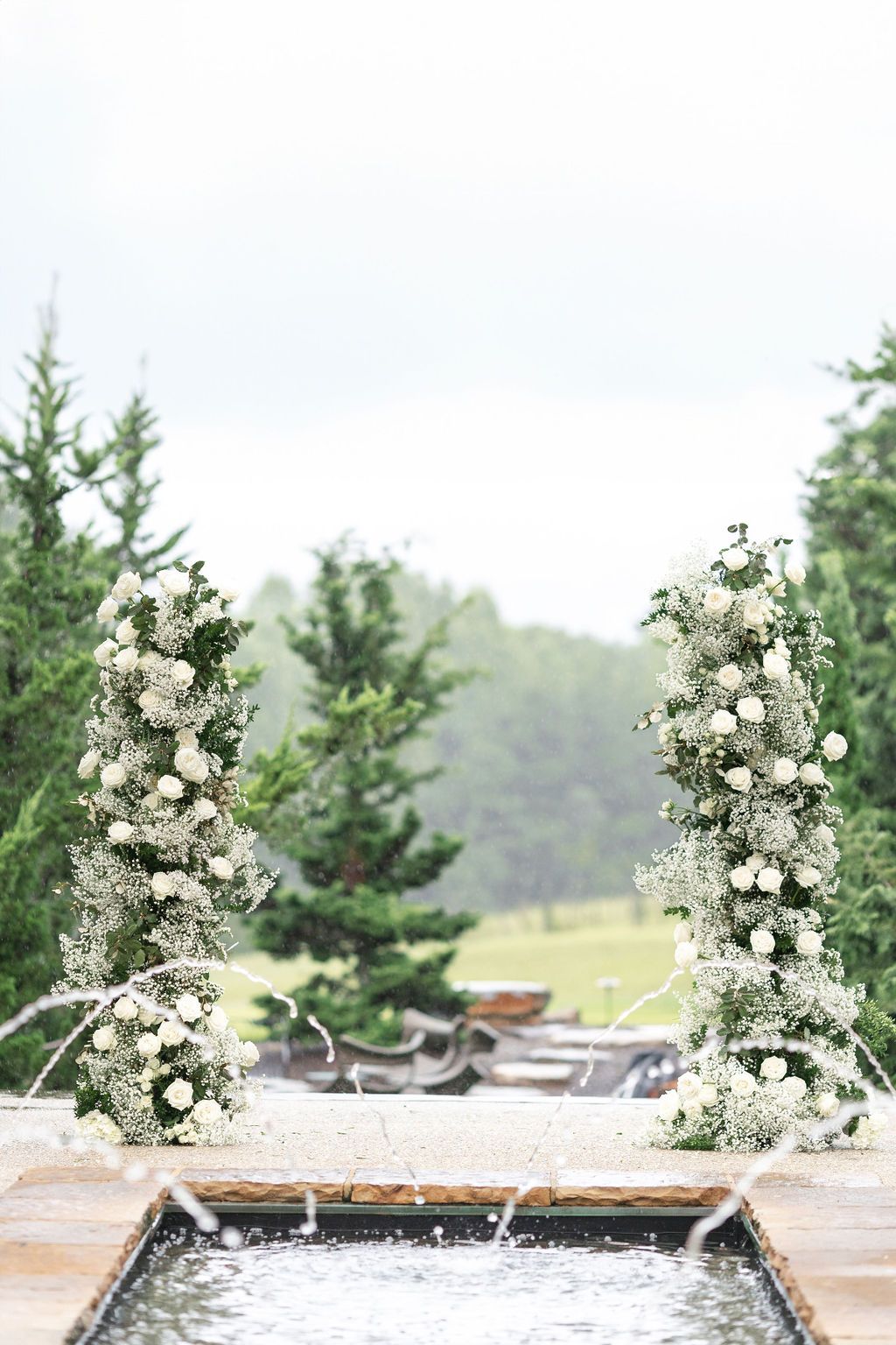 Floral wedding altarpiece in front of the fountain at Hotel Domestique