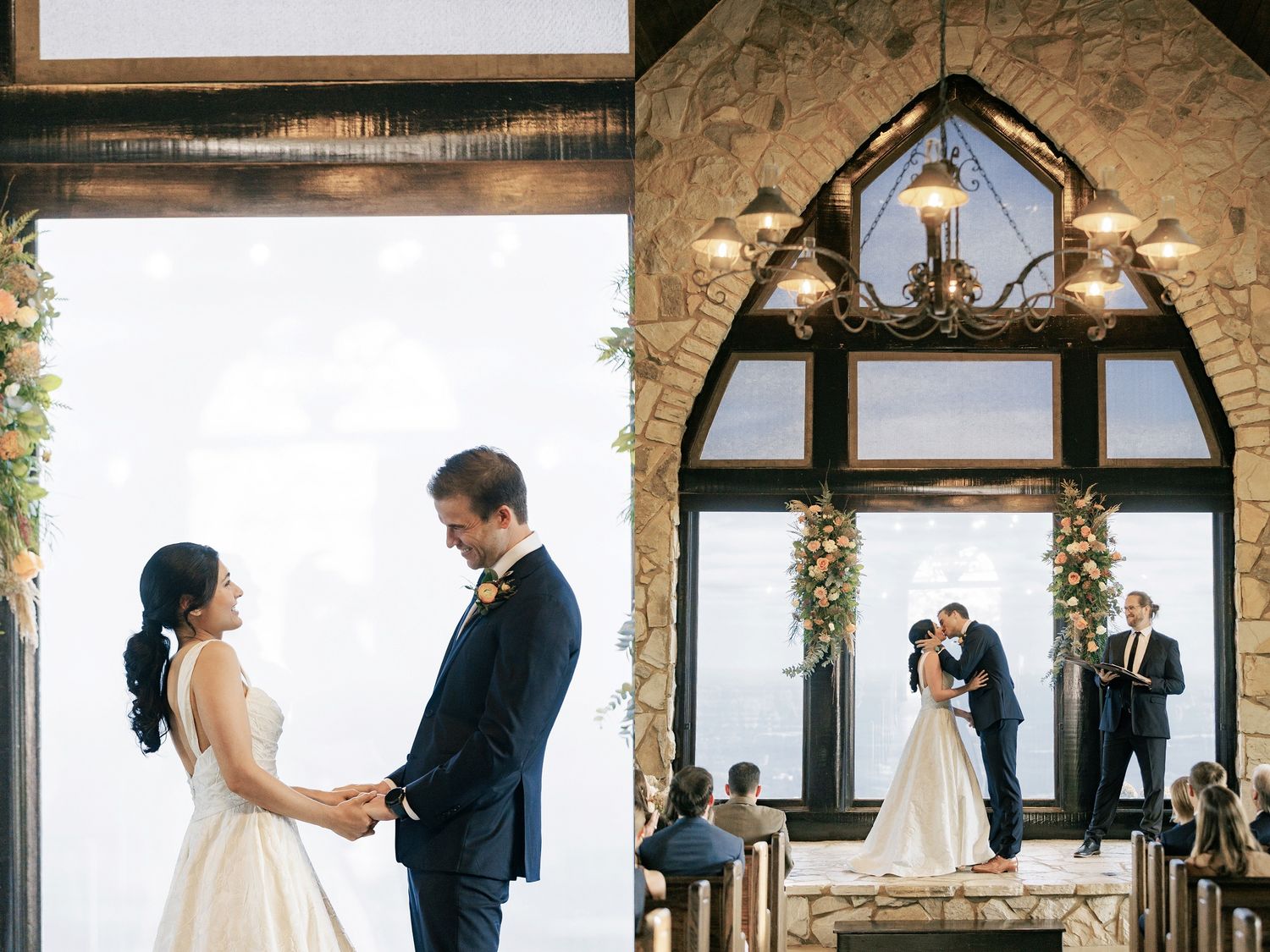 A romantic wedding couple stands silhouetted in front of large arched windows in a rustic stone venue.