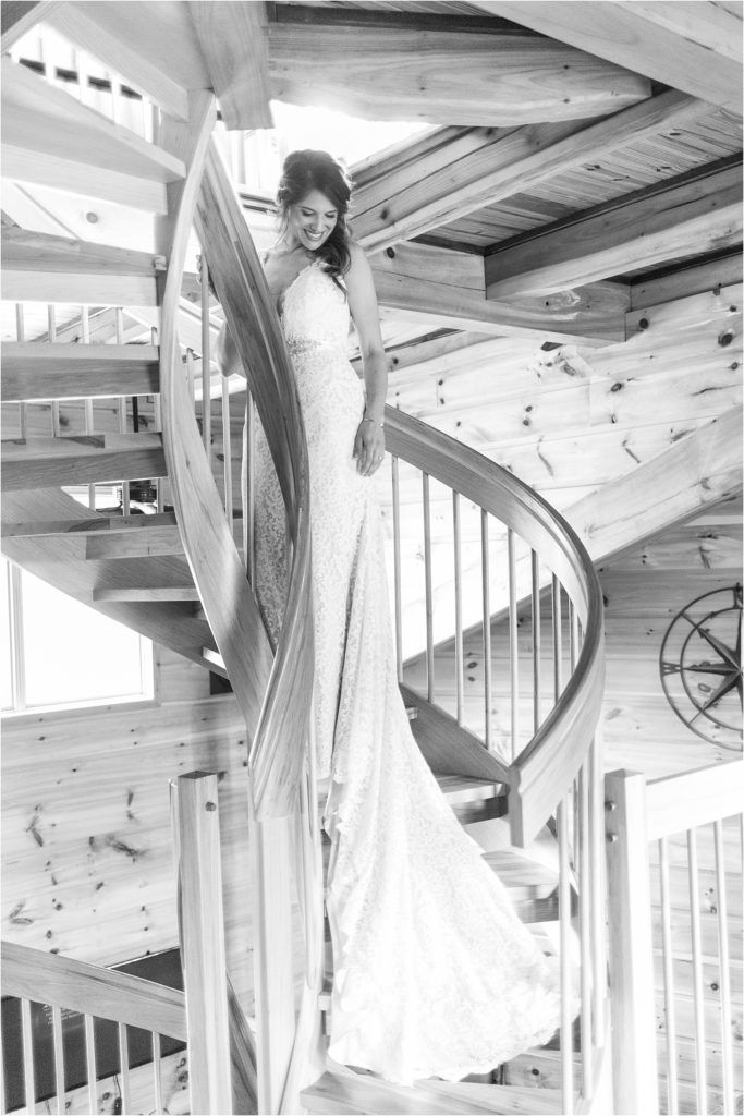 Elegant bridal portrait on spiral staircase in black and white.