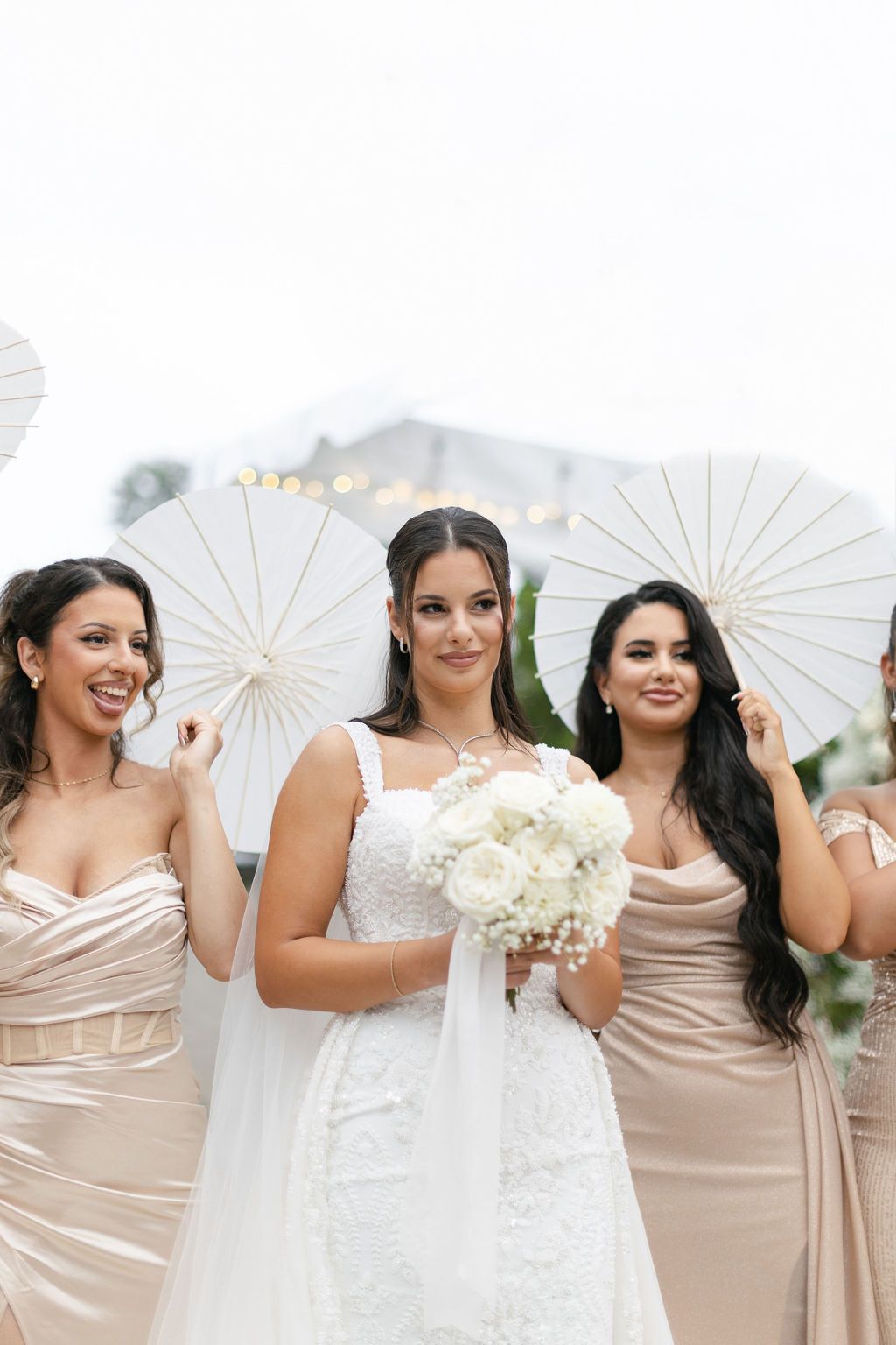 bridal party with white parasols