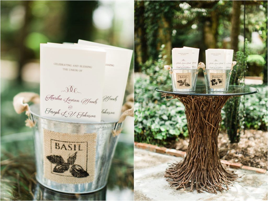Wedding programs in rustic metal buckets and wooden display stands with natural decor.