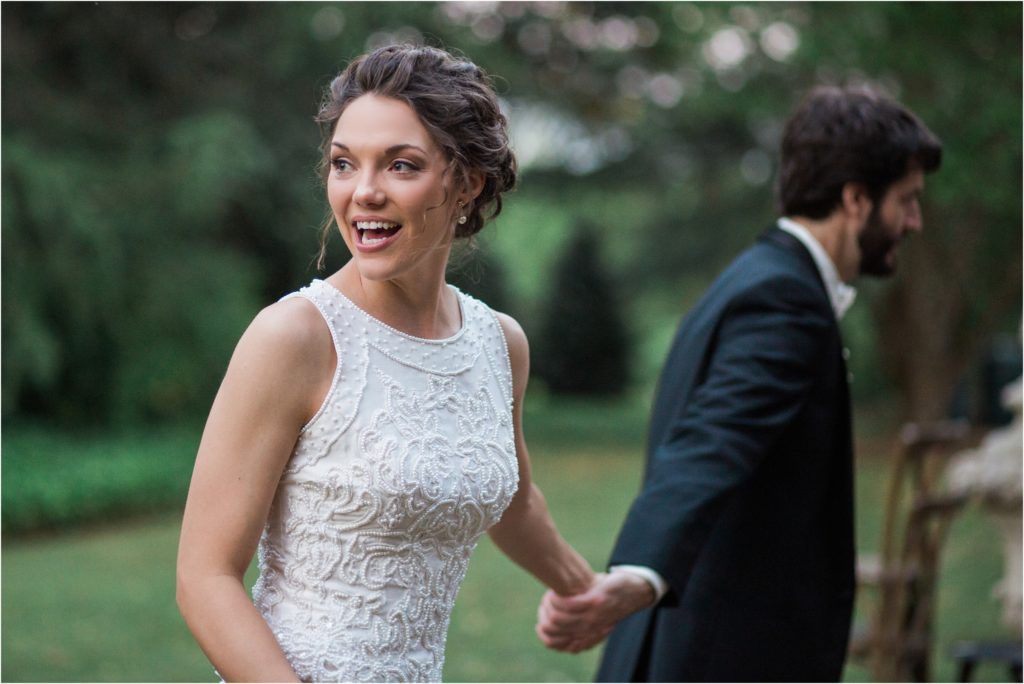 Candid moment captured during a garden wedding with elegant attire.