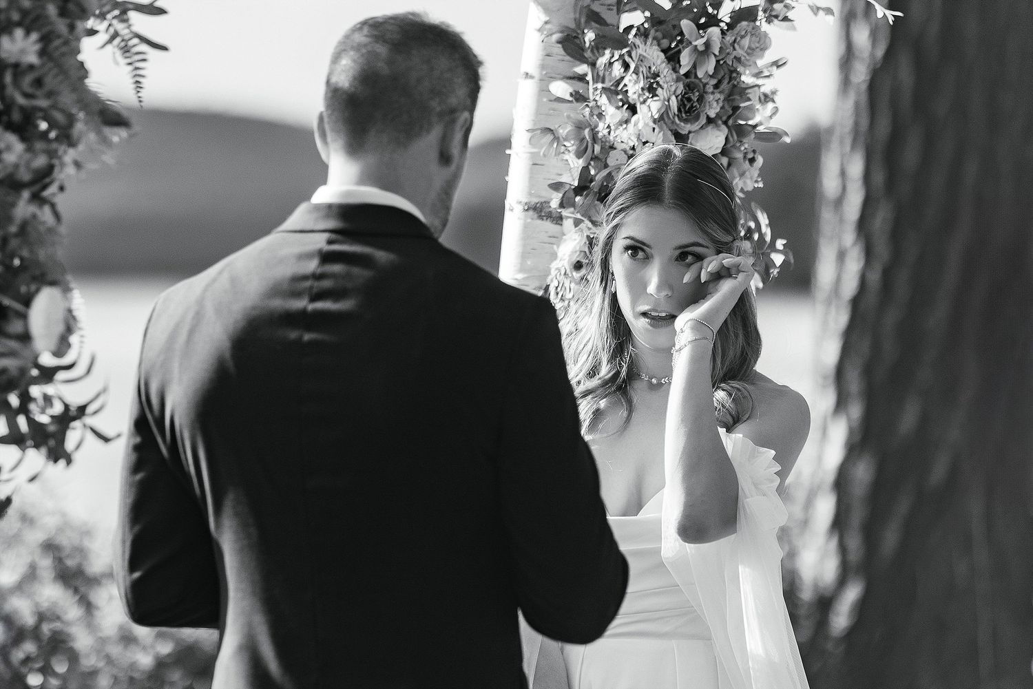 An emotional moment captured during wedding vows at an outdoor ceremony.