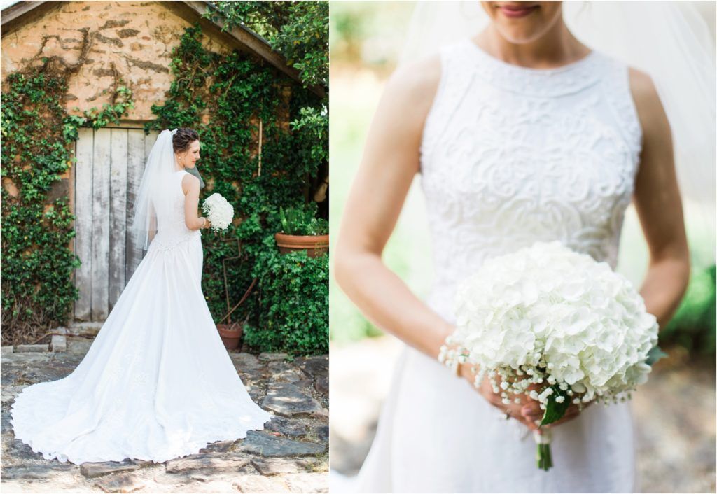 Classic white wedding dress with lace bodice and white bouquet in garden setting.