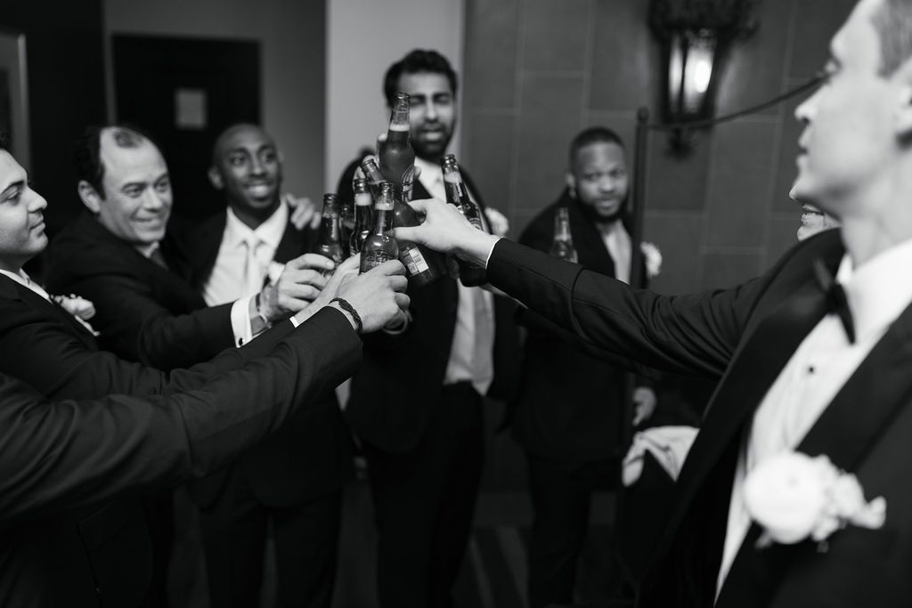 Groomsmen cheers to the groom before wedding ceremony