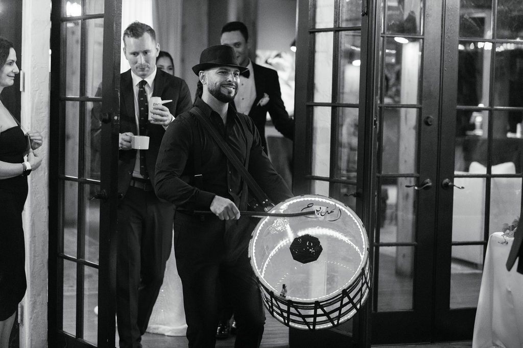 Wedding reception entertainment with drummer performing in black attire.