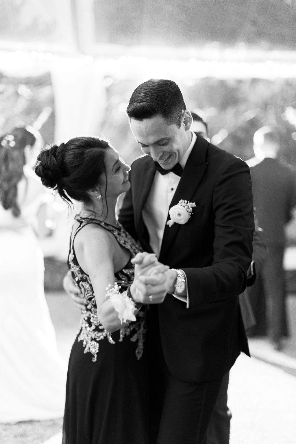 Black and white photo of a tender dance moment at an evening reception.