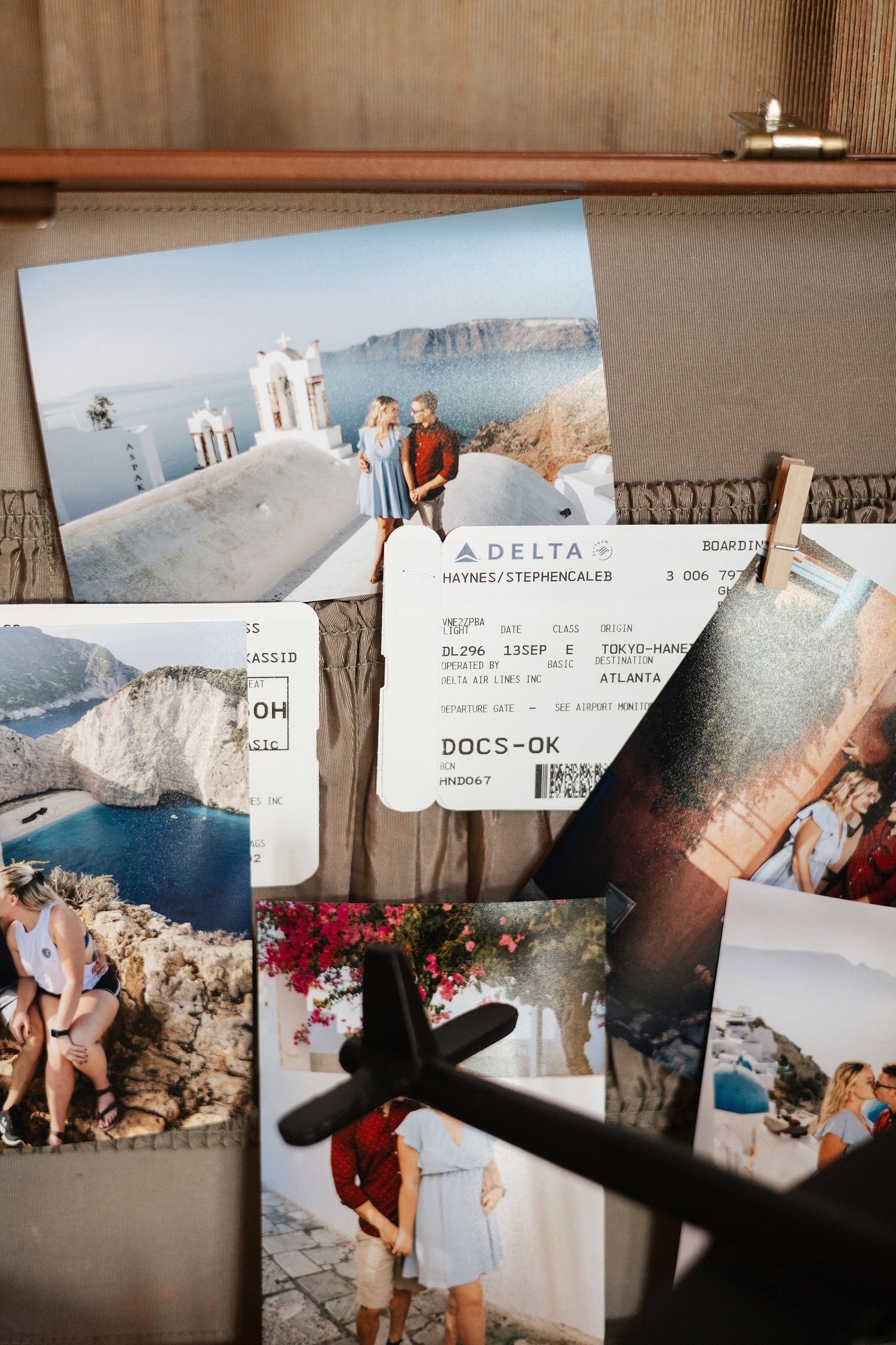 Travel memorabilia including photos from Greece with white buildings and coastal views alongside a Delta airline ticket.