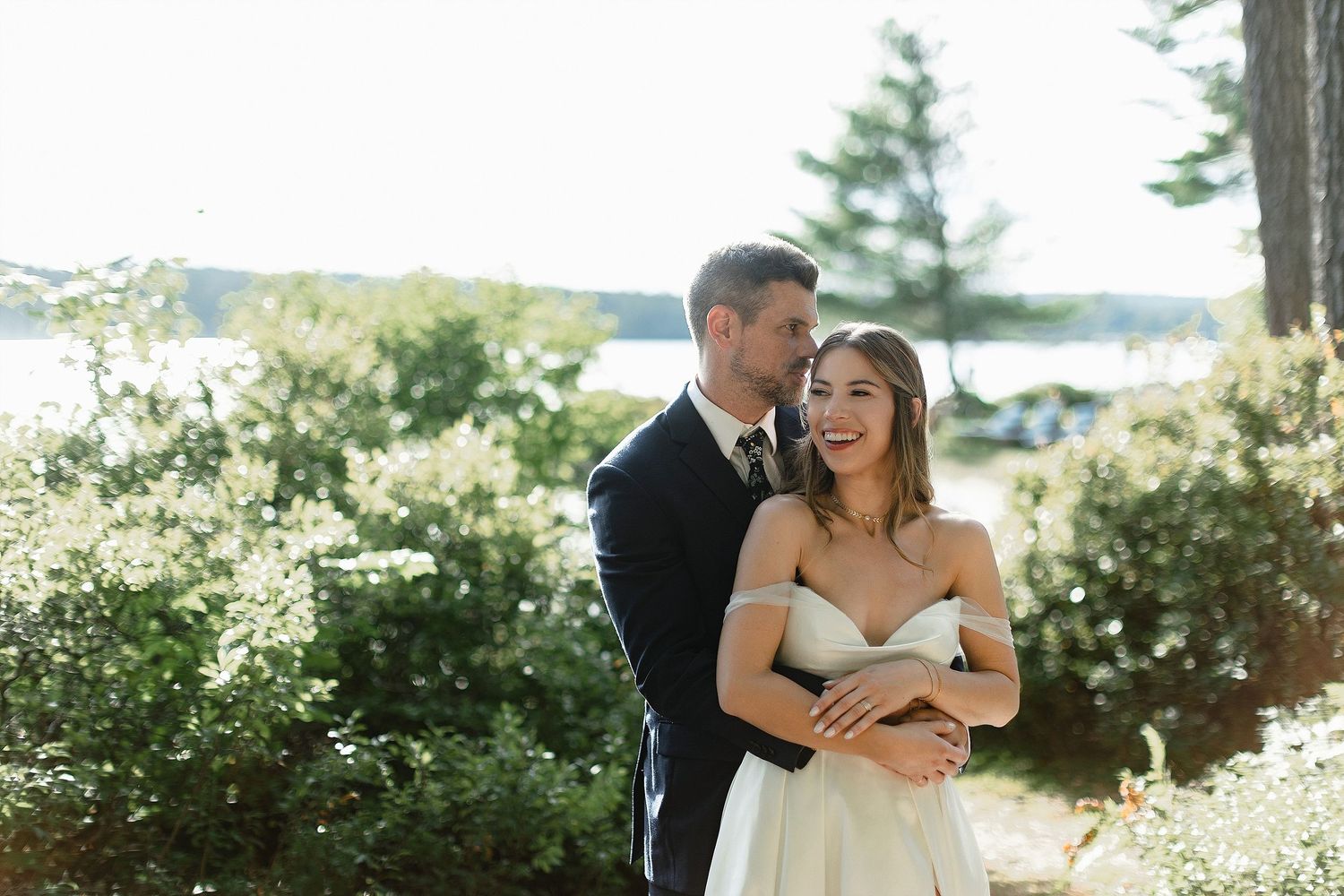A tender moment captured between newlyweds in a scenic outdoor setting.