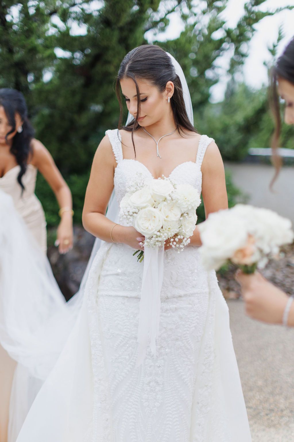 Bride in sweetheart lace beaded gown with detachable train