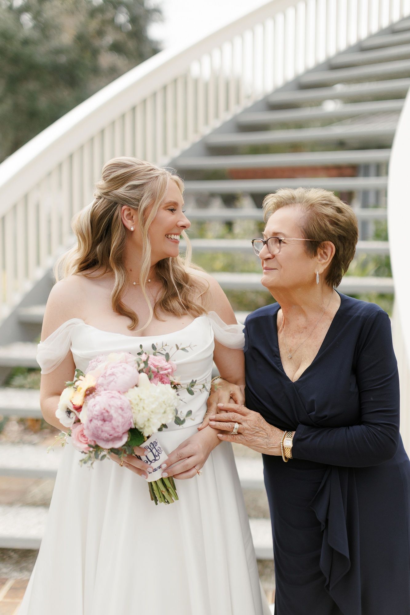 A series of candid moments captured between two people sharing joyful expressions at an outdoor wedding venue.
