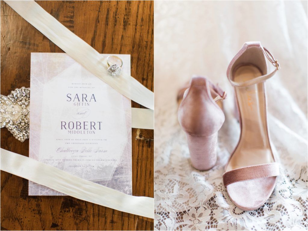 Wedding invitation and blush pink bridal shoes arranged with lace details.