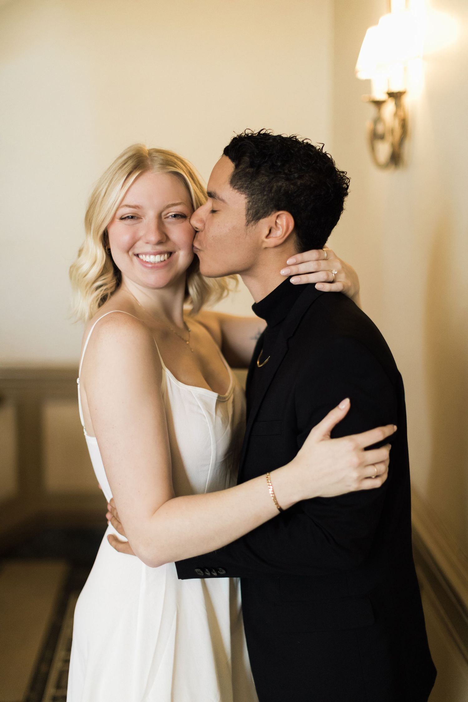 Groom to be kisses Bride to be's cheek