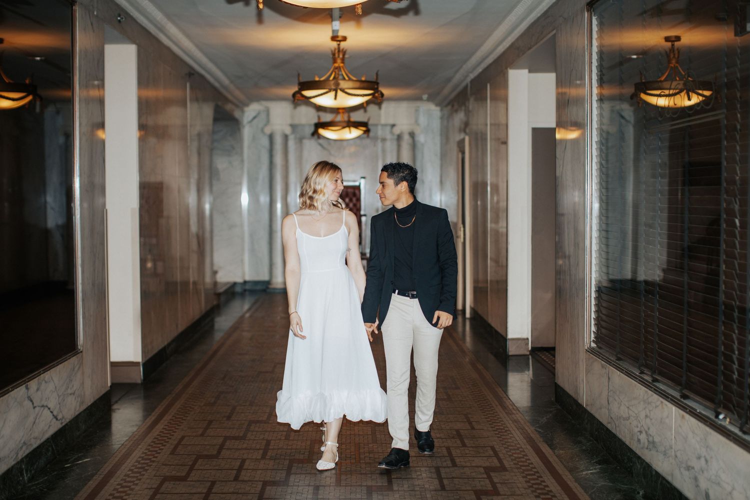 Couple walks down the hall of the Westin Poinsett Hotel
