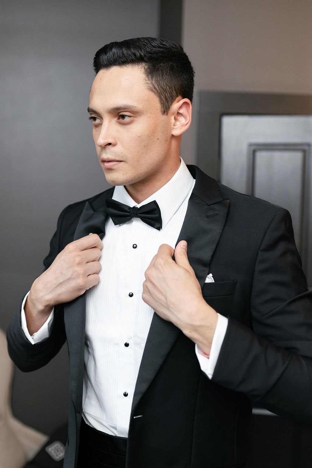 Groom in tux getting ready for wedding at Hotel Domestique