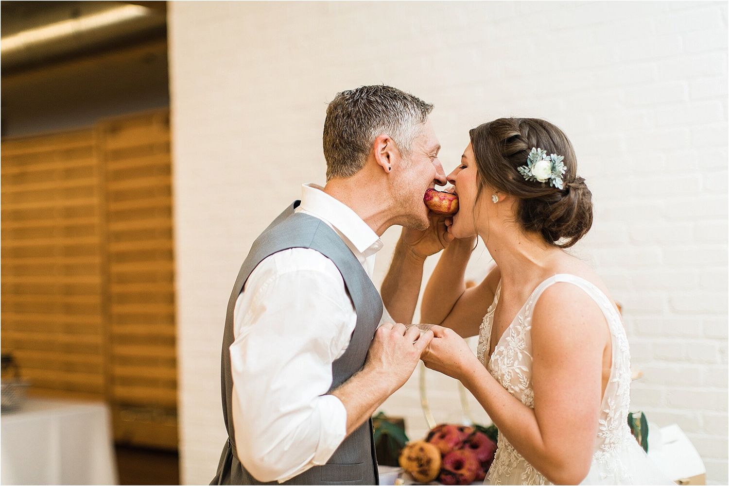 A tender moment shared between a couple during their wedding reception.